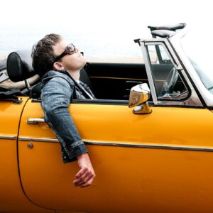 Man in yellow open top car