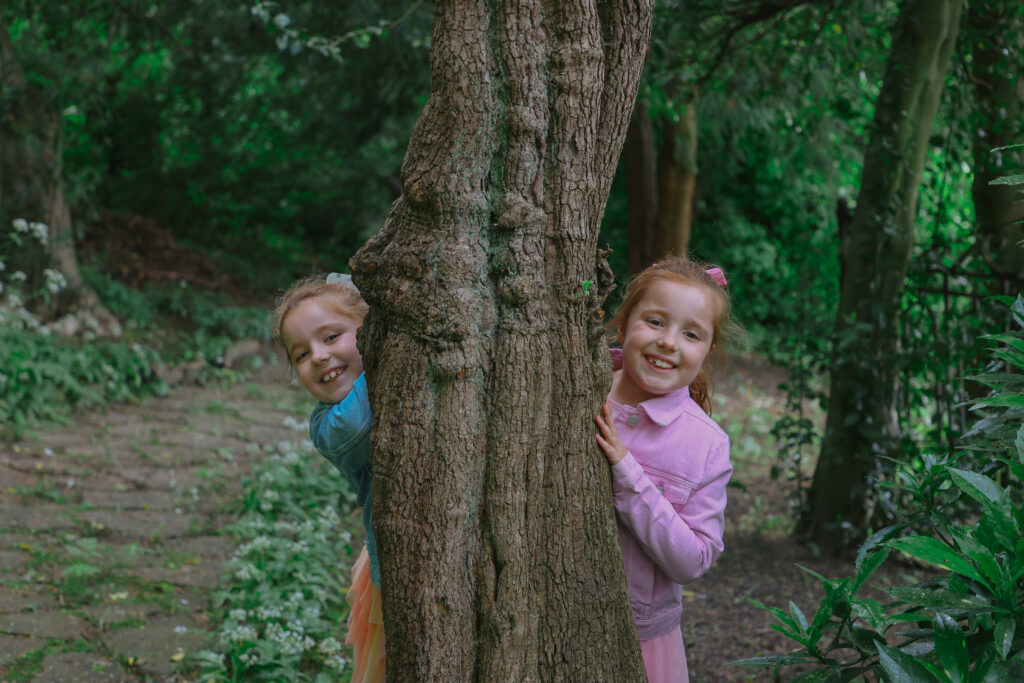 Twins Eloise and Emily with a tree