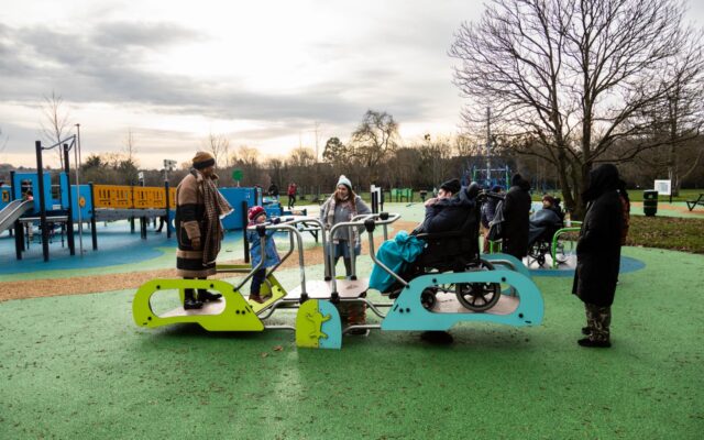 A wheelchair and non-wheelchair user using the accessible see-saw