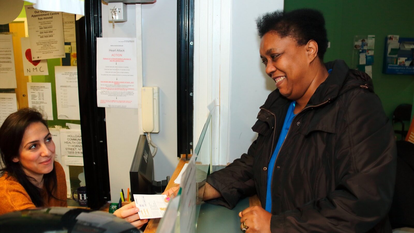 Woman at GP reception counter