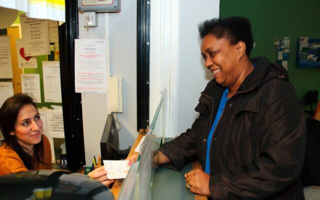 Woman at GP reception counter