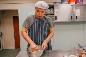Bingqing mixes flour butter