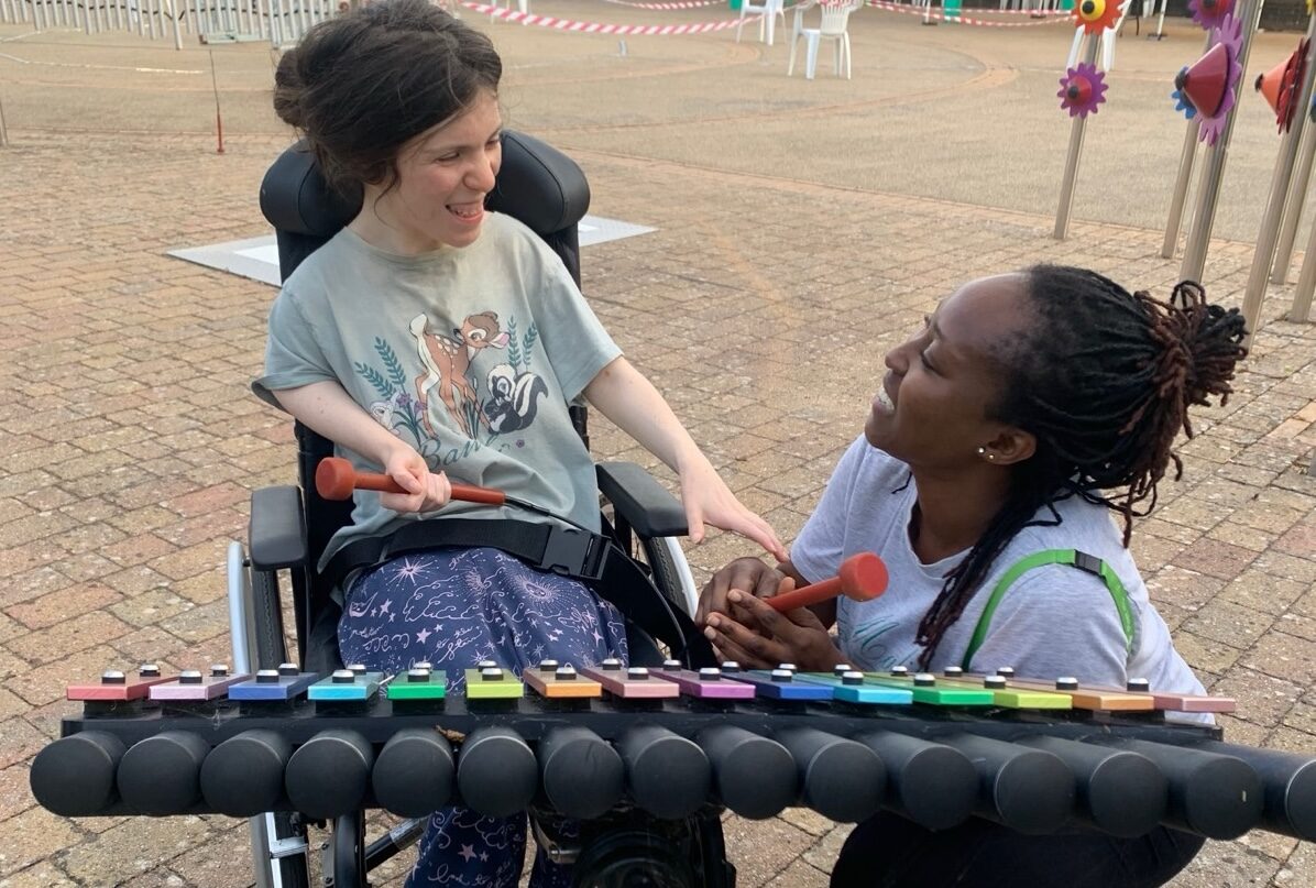 Elvi makes music with a support worker