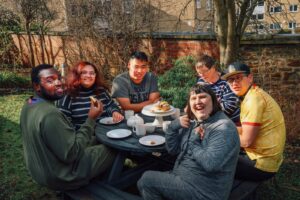 Group around outdoor table smiling