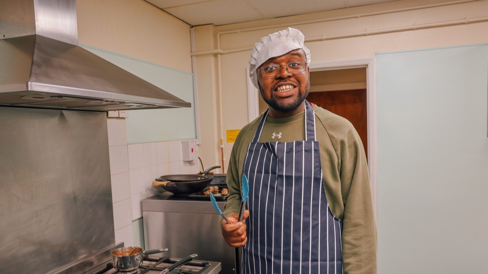 Nathan smiling while frying