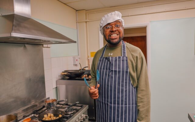 Nathan smiling while frying