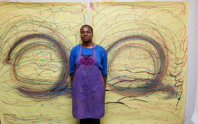 Nnena Kalu in front of a picture