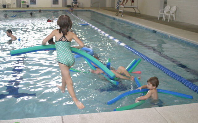 Girl jumping into swimming pool