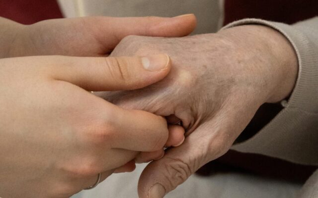 Holding hand of elderly person