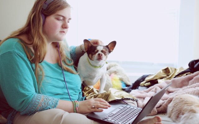 Woman with dog and laptop